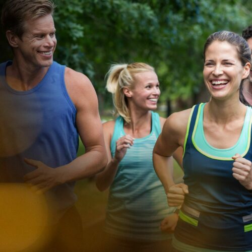 happy-men-women-jogging-street