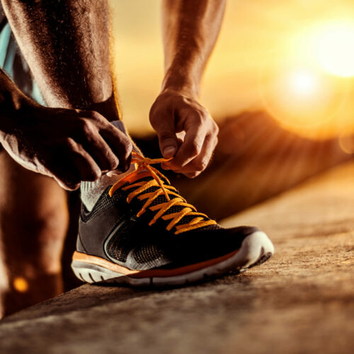 man-tying-jogging-shoes